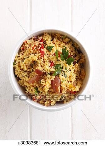 Stock Image - Close up of bowl of couscous. Fotosearch