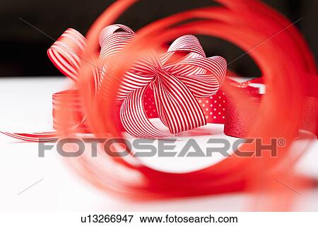 Close up of decorative red ribbons View Large Photo Image Stock Photo - Close up of decorative red ribbons. Fotosearch