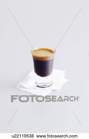 Stock Photo - Close up of glass of espresso. Fotosearch