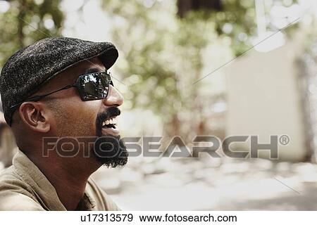 Stock Photo - Close up of laughing mans face. Fotosearch