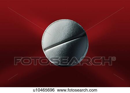Stock Photograph - Close up of pill on red surface. Fotosearch