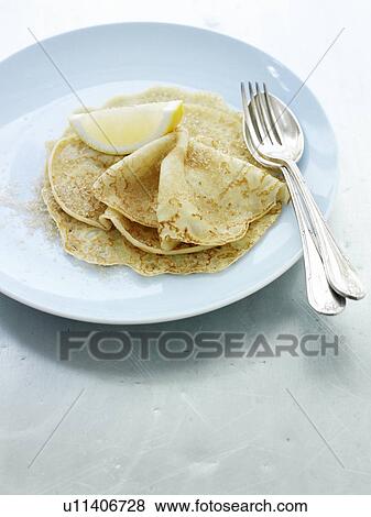 Close up of plate of crepes and lemon View Large Photo Image Stock Photo - Close up of plate of crepes and lemon. Fotosearch