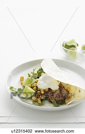 Stock Image - Close up of plate of meat taco. Fotosearch