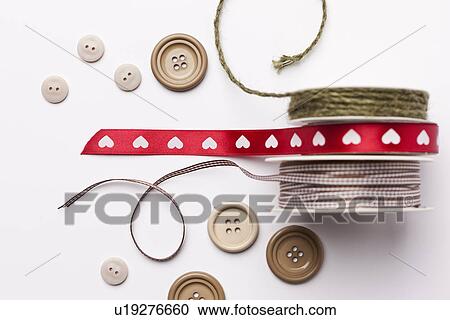 Stock Image - Close up of ribbon, string and buttons. Fotosearch