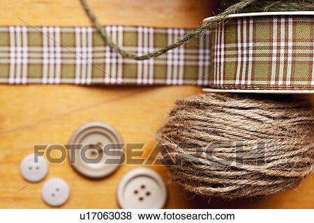 Stock Photo - Close up of ribbon, string and buttons. Fotosearch