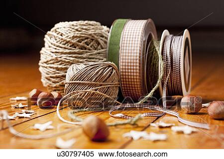 Stock Photography - Close up of ribbon, string and nuts. Fotosearch