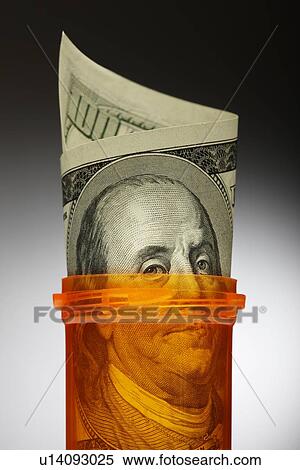 Close up of U. S. dollars in pill bottle View Large Photo Image Stock Photography - Close up of U. S. dollars in pill bottle. Fotosearch