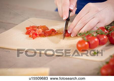 Close up of woman chopping tomatoes View Large Photo Image Stock Image - Close up of woman chopping tomatoes. Fotosearch