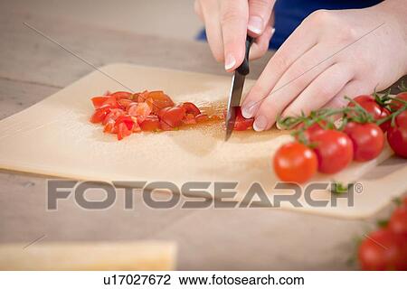 Close up of woman chopping tomatoes View Large Photo Image Stock Image - Close up of woman chopping tomatoes. Fotosearch