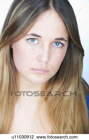 Stock Image - Close up of womans serious face. Fotosearch