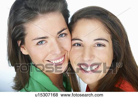 Stock Photo - Close up of women smiling together. Fotosearch