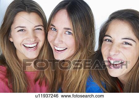 Stock Photograph - Close up of women smiling together. Fotosearch