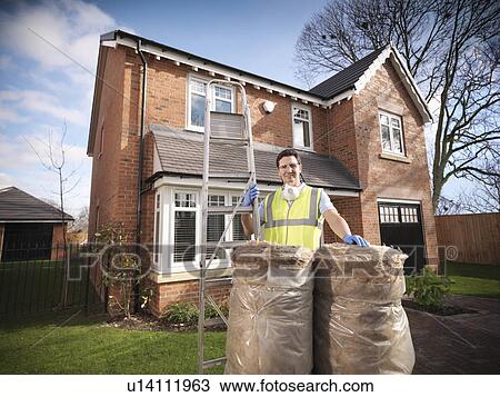 Contractor with rolls of insulation View Large Photo Image Stock Image - Contractor with rolls of insulation. Fotosearch