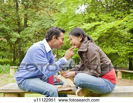 Couple having coffee in park View Large Photo Image Stock Image - Couple having coffee in park. Fotosearch