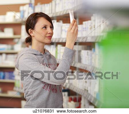 Stock Image - Customer browsing on drugstore shelves. Fotosearch