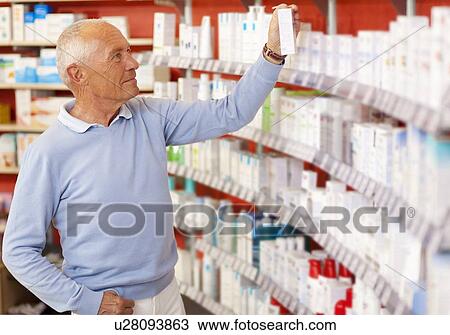 Stock Image - Customer browsing on drugstore shelves. Fotosearch