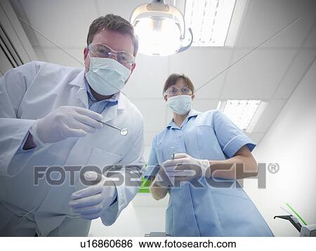 Dental student and dentist in surgery View Large Photo Image Stock Photograph - Dental student and dentist in surgery. Fotosearch