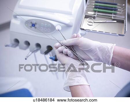 Dentist examining tools in surgery View Large Photo Image Picture - Dentist examining tools in surgery. Fotosearch