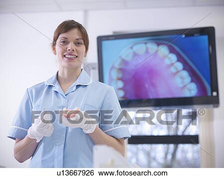 Dentist holding model of teeth in class View Large Photo Image Stock Photograph - Dentist holding model of teeth in class. Fotosearch