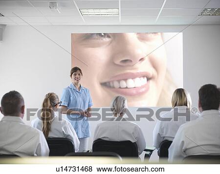 Dentist teaching students in class View Large Photo Image Stock Photo - Dentist teaching students in class. Fotosearch