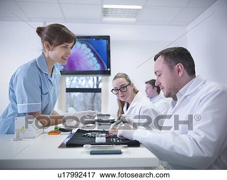 Dentist teaching students in class View Large Photo Image Stock Photo - Dentist teaching students in class. Fotosearch