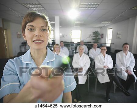 Dentist teaching students in class View Large Photo Image Stock Photography - Dentist teaching students in class. Fotosearch