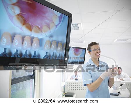 Dentist teaching students in lab View Large Photo Image Picture - Dentist teaching students in lab. Fotosearch