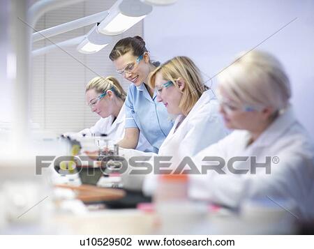 Dentist teaching students in lab View Large Photo Image Stock Image - Dentist teaching students in lab. Fotosearch
