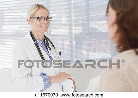 Doctor and patient talking in office View Large Photo Image Stock Image - Doctor and patient talking in office. Fotosearch