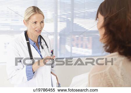 Doctor and patient talking in office View Large Photo Image Stock Photography - Doctor and patient talking in office. Fotosearch