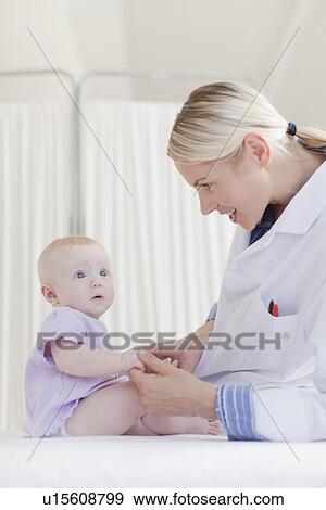 Stock Photo - Doctor examining baby in office. Fotosearch