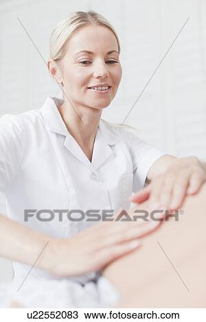 Doctor examining pregnant womans belly View Large Photo Image Stock Image - Doctor examining pregnant womans belly. Fotosearch