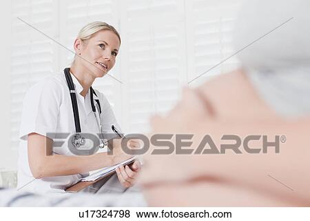 Doctor talking to pregnant woman View Large Photo Image Stock Photo - Doctor talking to pregnant woman. Fotosearch