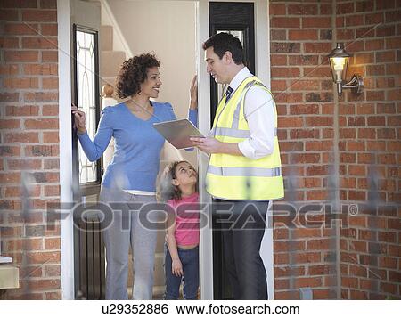 Stock Photograph - Energy worker talking to family. Fotosearch
