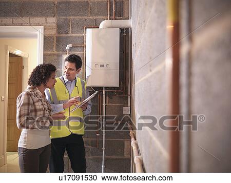 Energy worker talking with woman View Large Photo Image Stock Image - Energy worker talking with woman. Fotosearch