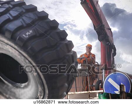 Engineer operating crane outdoors View Large Photo Image Stock Image - Engineer operating crane outdoors. Fotosearch