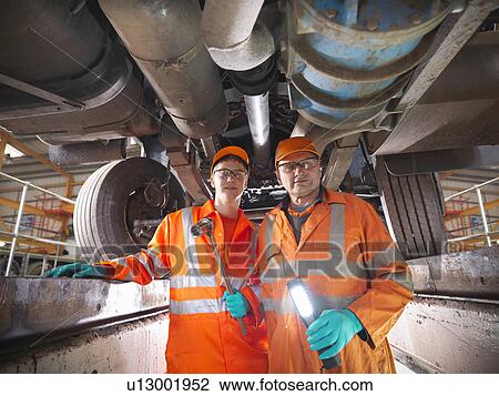 Engineer teaching apprentice in factory View Large Photo Image Stock Image - Engineer teaching apprentice in factory. Fotosearch