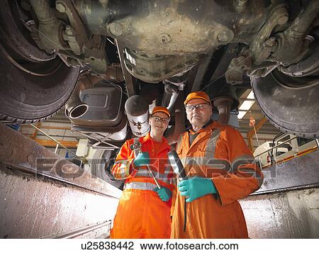 Engineer teaching apprentice in factory View Large Photo Image Stock Image - Engineer teaching apprentice in factory. Fotosearch