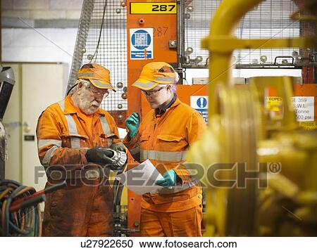 Engineer teaching apprentice in factory View Large Photo Image Stock Image - Engineer teaching apprentice in factory. Fotosearch