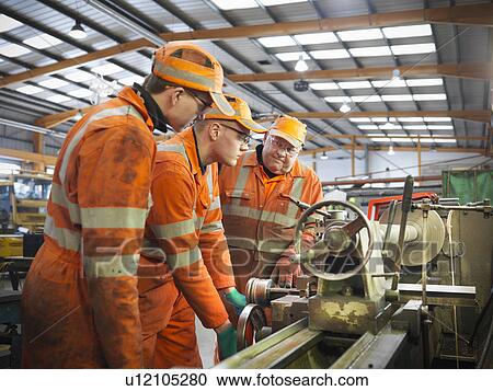 Engineer teaching apprentices in factory View Large Photo Image Stock Image - Engineer teaching apprentices in factory. Fotosearch