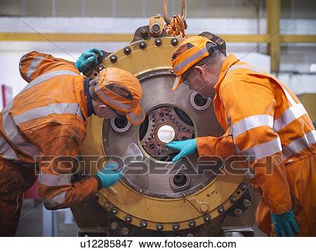 Engineer teaching apprentices in factory View Large Photo Image Stock Photo - Engineer teaching apprentices in factory. Fotosearch