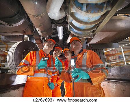 Engineer teaching apprentices in factory View Large Photo Image Stock Photo - Engineer teaching apprentices in factory. Fotosearch