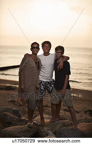Family hugging on beach View Large Photo Image Stock Photo - Family hugging on beach. Fotosearch