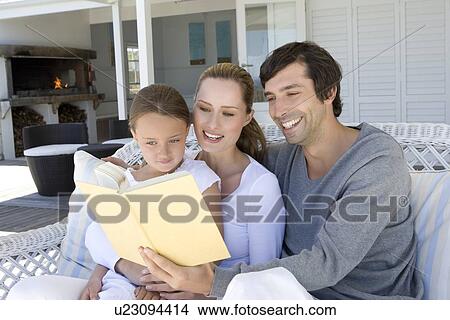 Family reading on sofa together View Large Photo Image Picture - Family reading on sofa together. Fotosearch