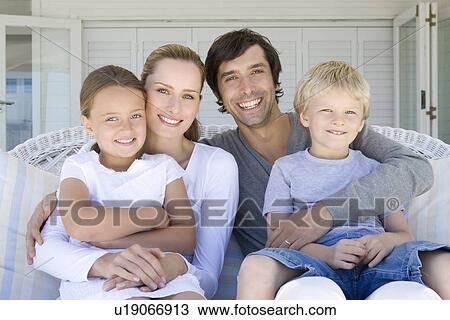 Family relaxing on sofa together View Large Photo Image Stock Image - Family relaxing on sofa together. Fotosearch