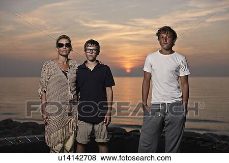 Stock Photo - Family standing on trampoline. Fotosearch