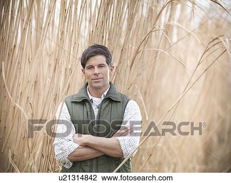 Farmer standing in elephant grass View Large Photo Image Stock Image - Farmer standing in elephant grass. Fotosearch