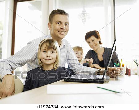Picture - Father and daughter using laptop. Fotosearch