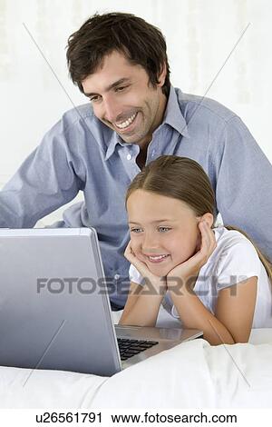 Father and daughter using laptop View Large Photo Image Stock Image - Father and daughter using laptop. Fotosearch