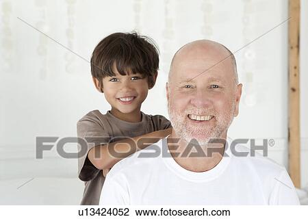 Stock Image - Father and son smiling together. Fotosearch